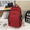Mochila de viaje versátil estilo coreano para parejas con bordado de letras, mochila escolar elegante y duradera para chicos de secundaria y preparatoria