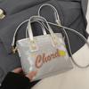 Venta al por mayor popular nicho personalidad impresión de letras bolsa de cubo portátil moda alta textura bandolera para ir al trabajo mujeres