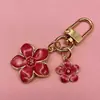 Colgante de llavero de flor de metal transfronterizo, decoración de flor simple y juvenil para teléfono, accesorio colgante para bolso