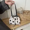 La popular bolsa pequeña de lunares de este año para mujer 2026 nueva elegante versátil bandolera exquisita bolsa cubo con cordón venta al por mayor