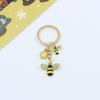 Llavero de abeja pequeña transfronterizo colgante de flor de panal abeja anillo de llavero de aleación gota de aceite colgante de bolsa joyería al por mayor