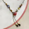 Collar con colgante de campana de mariposa de cerámica de estilo étnico retro para mujer, diseño nuevo y moderno, cadena larga para suéter, accesorios