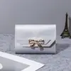 Bolsas Femininas Mais Vendidas no Exterior 2026Bolsas Laço Estilo Curto 70% de desconto Botão de Pressão Carteira Feminina Mini Barata Bolsa Pequena