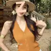 Chaleco de punto naranja con cuello halter en V para mujer, de un solo pecho, corte ajustado, top sin mangas tipo camisola Verano 2026