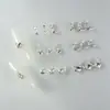 Novos designs de nail art com adornos de zircônia cúbica de alta qualidade, leves e luxuosos, incluindo strass nas pontas dos dedos estilo francês, decorações de unha versáteis e deslumbrantes, e motivos de coração e borboleta