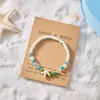 Moda de verão pulseira trançada com contas pequenas e frescas pulseira criativa versátil de contas de arroz de praia com estrela-do-mar feminina em estoque atacado