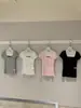 Wgwe9491 Ropa de Mujer Shisanxing de Guangzhou 2026 Verano Nuevo Cuello Redondo Cintura Ceñida Versátil Manga Corta Camiseta Top Delgado