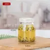 En stock al por mayor botella de pudín botella de vidrio botella de mermelada botella de yogur al por mayor vidrio transparente engrosado con tapa sellada