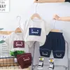 Comercio Exterior Ropa Infantil al por Mayor 2025 Nuevo Verano Lindo Cuadrado Cara Sonriente Traje de Manga Corta Camiseta Pantalones Cortos Traje