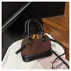 Bolsa de concha de diseño de nicho transfronteriza 2026 otoño nuevo bolso de mano de moda bolso de hombro cruzado versátil retro