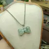Popular Colgante de Jade Oreja de Gato Natural Anillo de Jade Verde Tianshan Paz Hebilla de Paz de Jade Donut Colgante Venta al por Mayor
