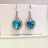 Aretes de moda europea y americana con forma de corazón de cristal austriaco, aretes de aleación, corazón de gema oceánica, venta al por mayor