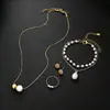 Conjunto de cuatro piezas de perlas estilo francés: conjunto de collar, pulsera, aretes y anillo, conjunto de joyería versátil y moderno de lujo ligero para mujer