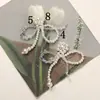 Japonés y Coreano Simple Versátil Perla Artificial Cristal Lazo DIY Bolsa Colgante para Teléfono Hebilla de Zapato Flor de Zapato Accesorios para Pendientes