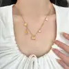 Collar con colgante de bolsa de filigrana fructífera chapado en oro de 18 quilates antiguo, borla, florecilla, cadena para la clavícula de lujo ligero de alta gama