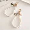 Creativo Elegante Nuevo Colgante de Mariposa de Perla Artificial DIY Llavero de Equipaje Colgante Cámara CCD Correa para Teléfono Móvil Oreja