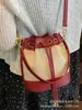 Bolsos de Diseño Nicho para Mujer 2025 Nuevo Verano Versátil Super Popular Bolso Cruzado Estilo Coreano Cordón Mini Bolso Cubo