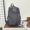 Mochila de viaje de color sólido elegante para viajes cortos, estilo japonés, bolso de doble hombro estilo ins, estilo simple, modelo para pareja, acabado mate minimalista relajado