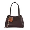 Bolso de mano texturizado de alta gama para mujer, nuevo bolso de hombro de moda niche para el verano 2026, popular y versátil