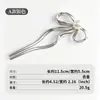 Pasador de aleación en forma de U transfronterizo con un diseño de moño de lujo ligero, accesorio para el cabello de alta gama para mujeres de estilo europeo y americano, pasador dorado y plateado