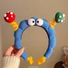 2025 Novo Fofo Azul Olho Grande Torcido Plush Aro de Cabelo Feminino Engraçado Placa de Licença Divertido Lavar Cabelo Cartão Acessório de Cabeça
