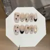 Un juego de uñas postizas [Luz de las Estrellas de Medianoche] con rubor en polvo negro dulce y fresco con estrellas y puntos, tipo prensa francesa
