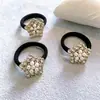 Joyería de moda simple al por mayor perla + diamantes de imitación cuerda para niñas coleta anillo de pelo negro sin costuras anillo de toalla