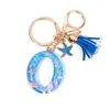Llavero Colgante Temático Océano Azul con Borla de Estrella de Mar, Llavero de Resina Encanto para Bolso con 26 Letras