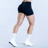 Shorts de yoga sin costuras cruzados en la cintura para mujer, adecuados para correr y fitness, con características de realce de glúteos y control de abdomen, shorts de tres cuartos de secado rápido y transpirables de efecto "pompa de durazno"